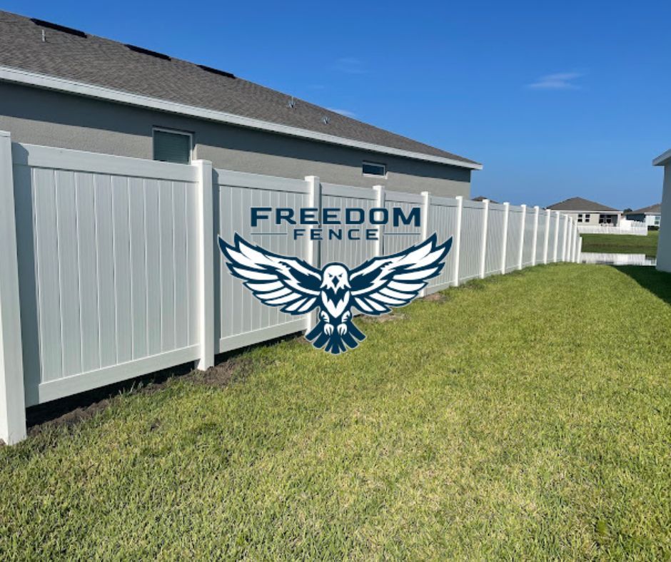 a white high fence with freedom fence logo