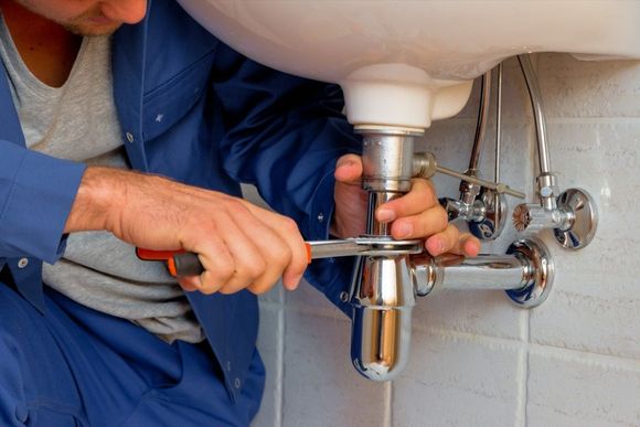 Plumber installing a new pipe fitting