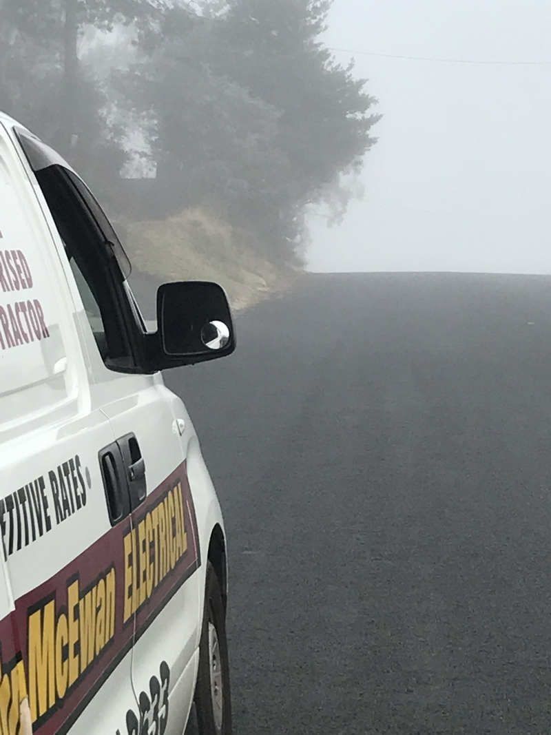 An Electrical Truck is Parked on the Side of the Road — John McEwan Electrical in Dapto, NSW