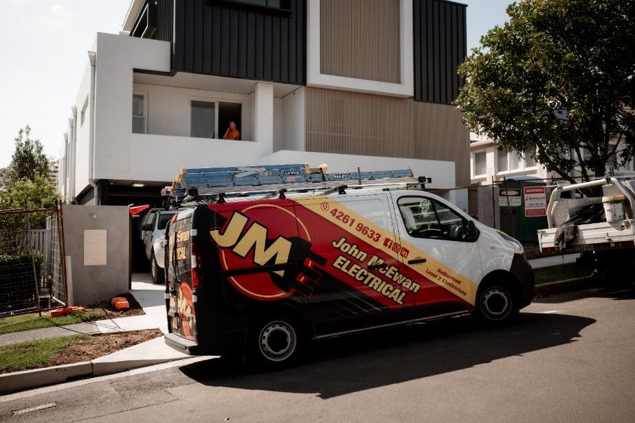 A JME Electrical Van is Parked in Front of a House — John McEwan Electrical In Calderwood, NSW