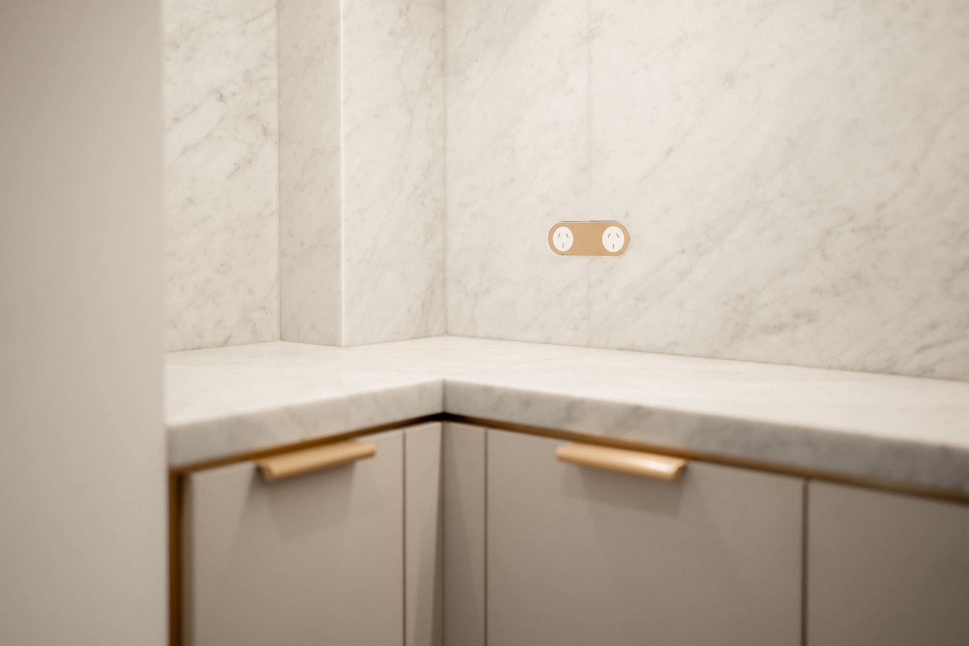 A Kitchen With White Cabinets and Marble Counter Tops — John McEwan Electrical In Unanderra, NSW