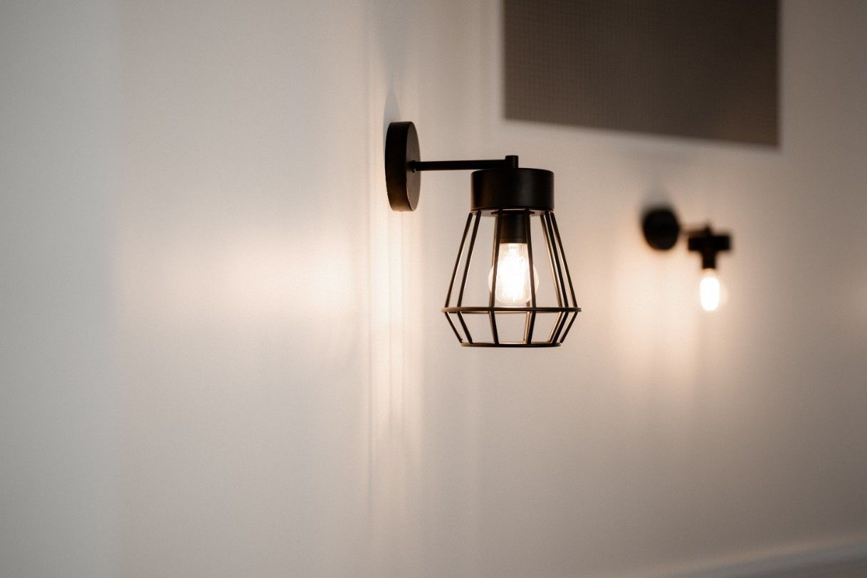 A Light Fixture is Hanging on a White Wall — John McEwan Electrical in Southern Highlands, NSW