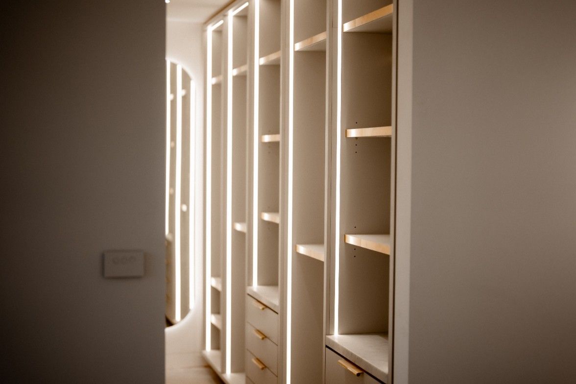 A Walk in Closet With Lots of Shelves and Drawers — John McEwan Electrical in Albion Park, NSW