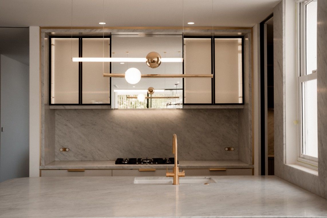 A Kitchen With a Stove Top Oven and a Sink — John McEwan Electrical in Woonona, NSW