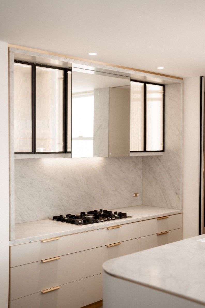 A Kitchen With White Cabinets and a Stove Top Oven — John McEwan Electrical in Dapto, NSW