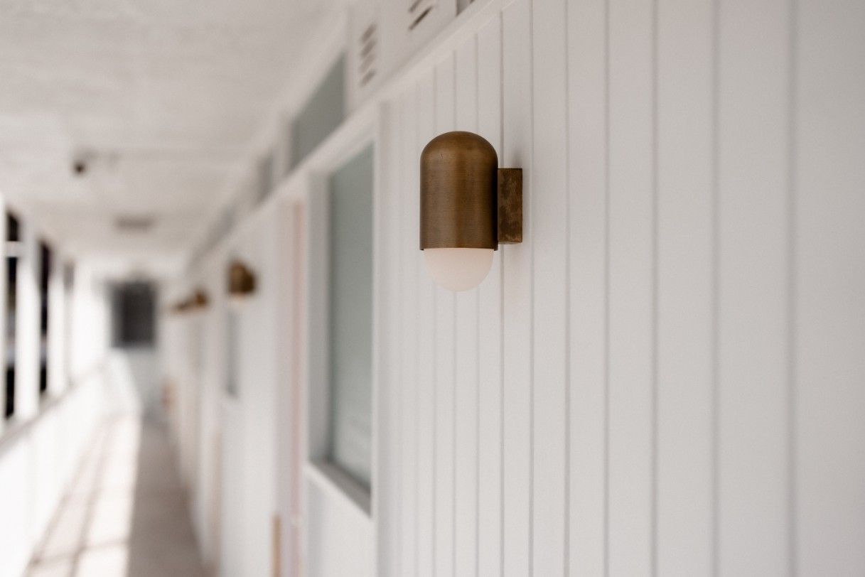 A Hallway With White Walls and a Light on the Wall — John McEwan Electrical in Unanderra, NSW