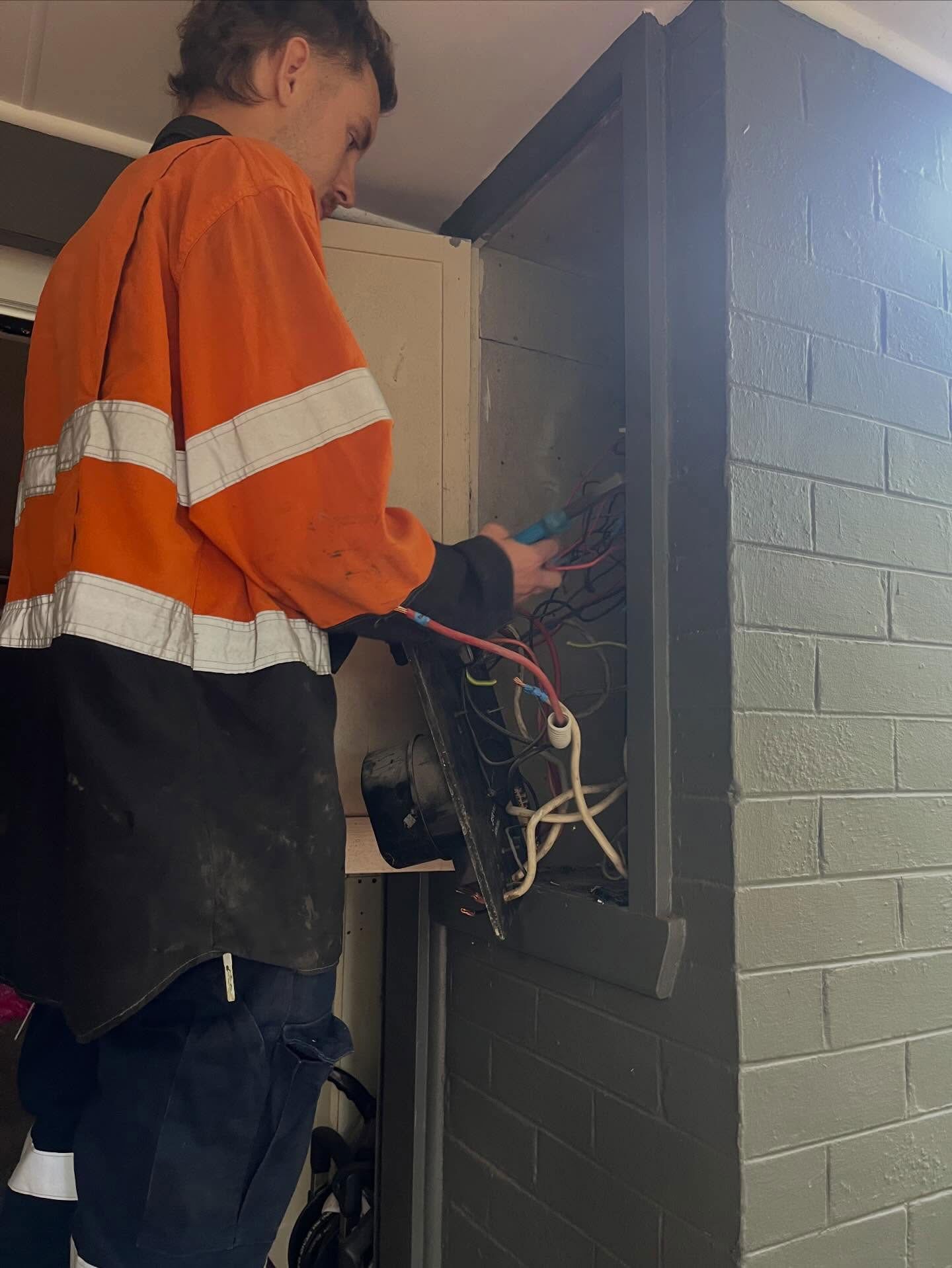 Electrician Working On An Electrical Box