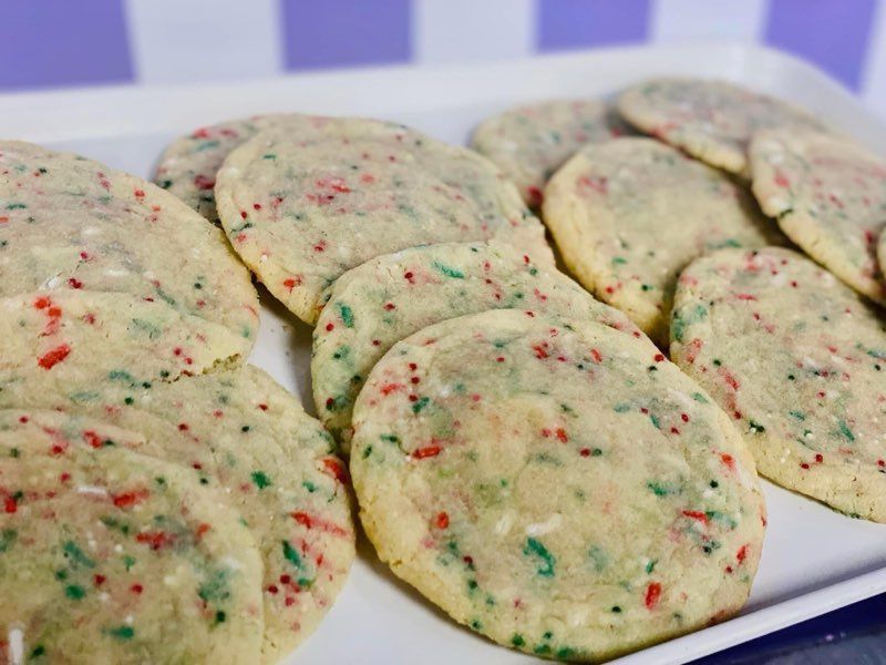 A tray of cookies with sprinkles on them