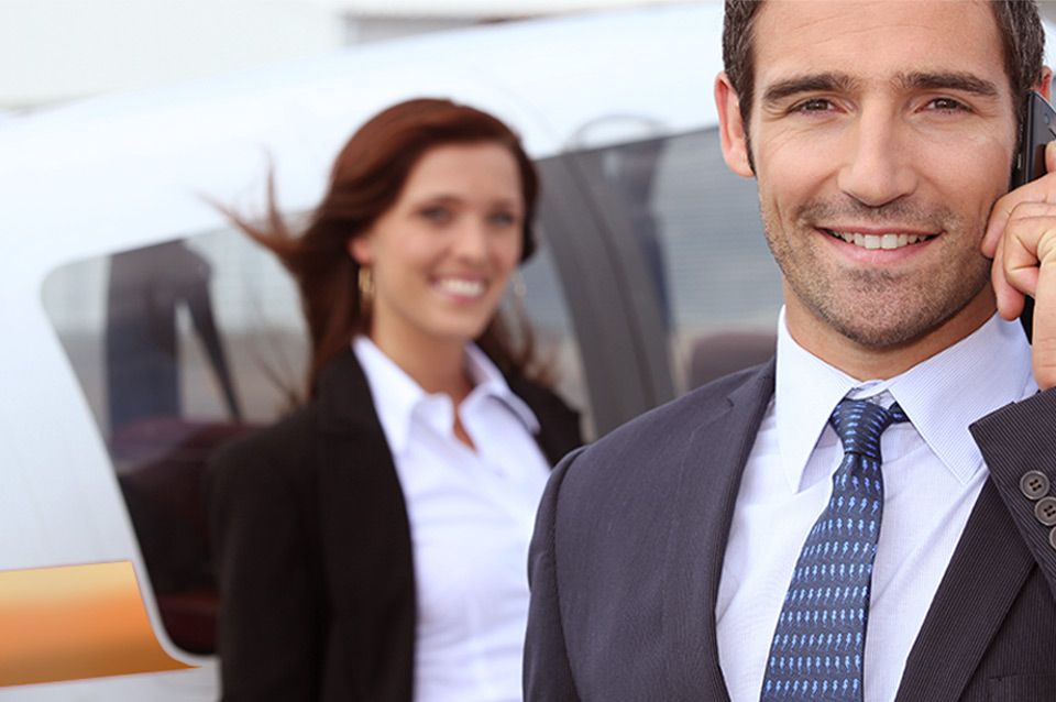A man in a suit and tie is talking on a cell phone