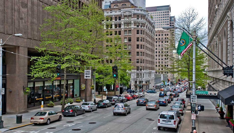A city street with a lot of cars driving down it