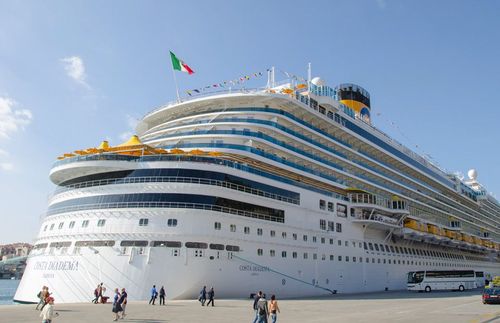 A large cruise ship is docked in a harbor.