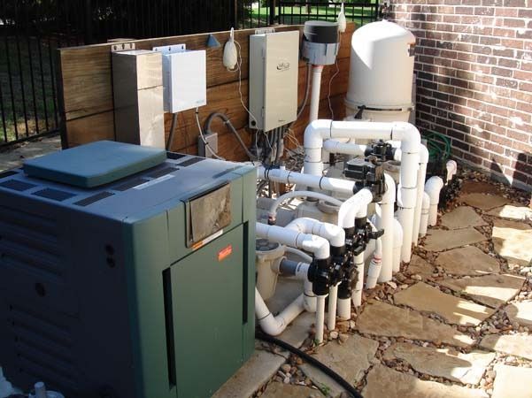 A swimming pool with a lot of pipes connected to it