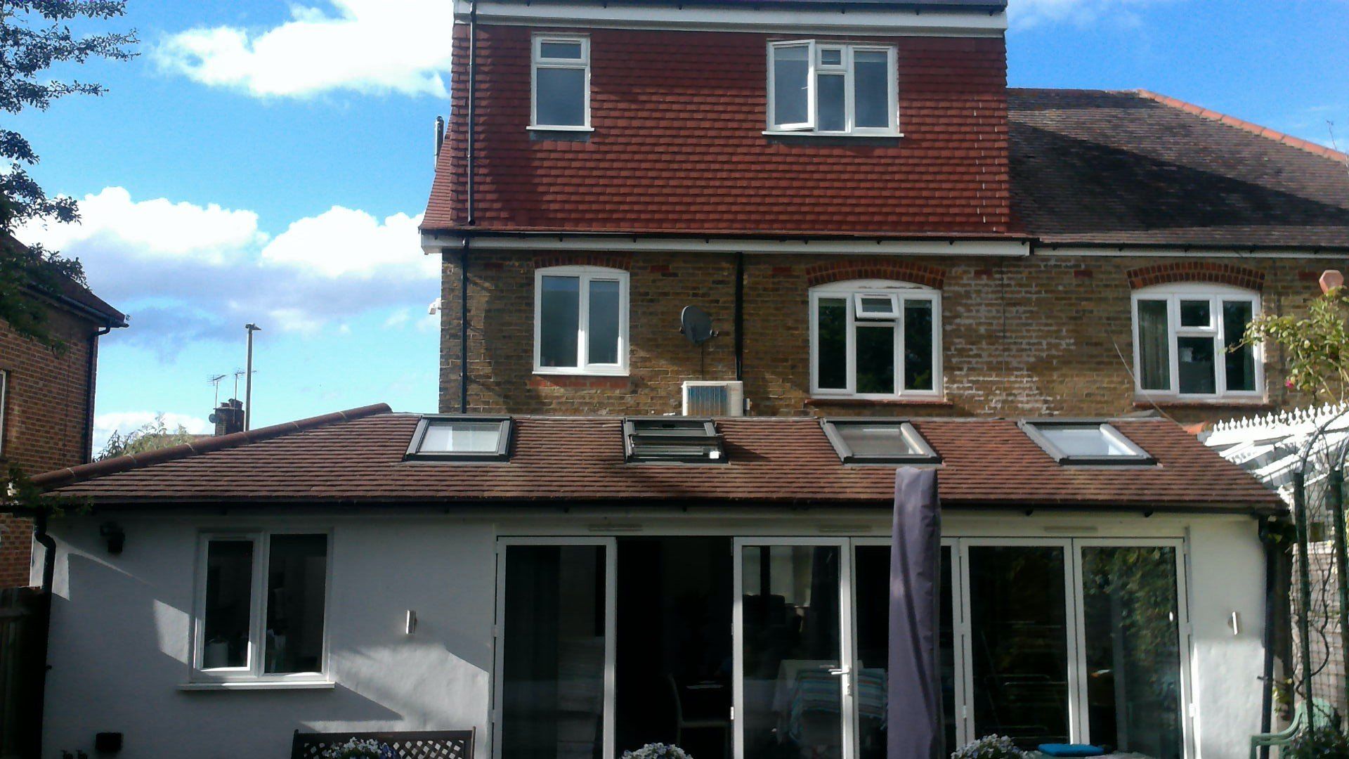 The back of a house with a skylight on the roof