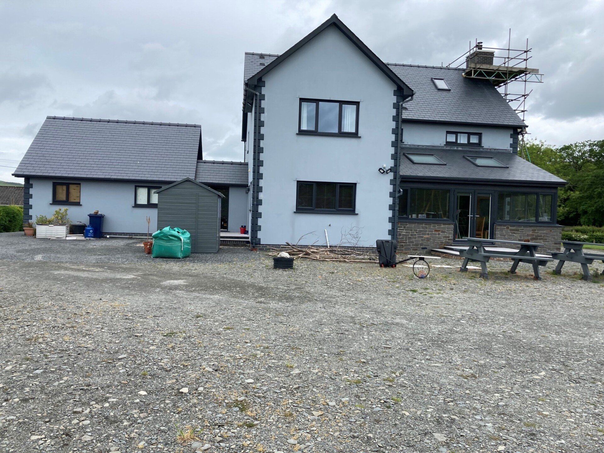 A large house with a gravel driveway in front of it