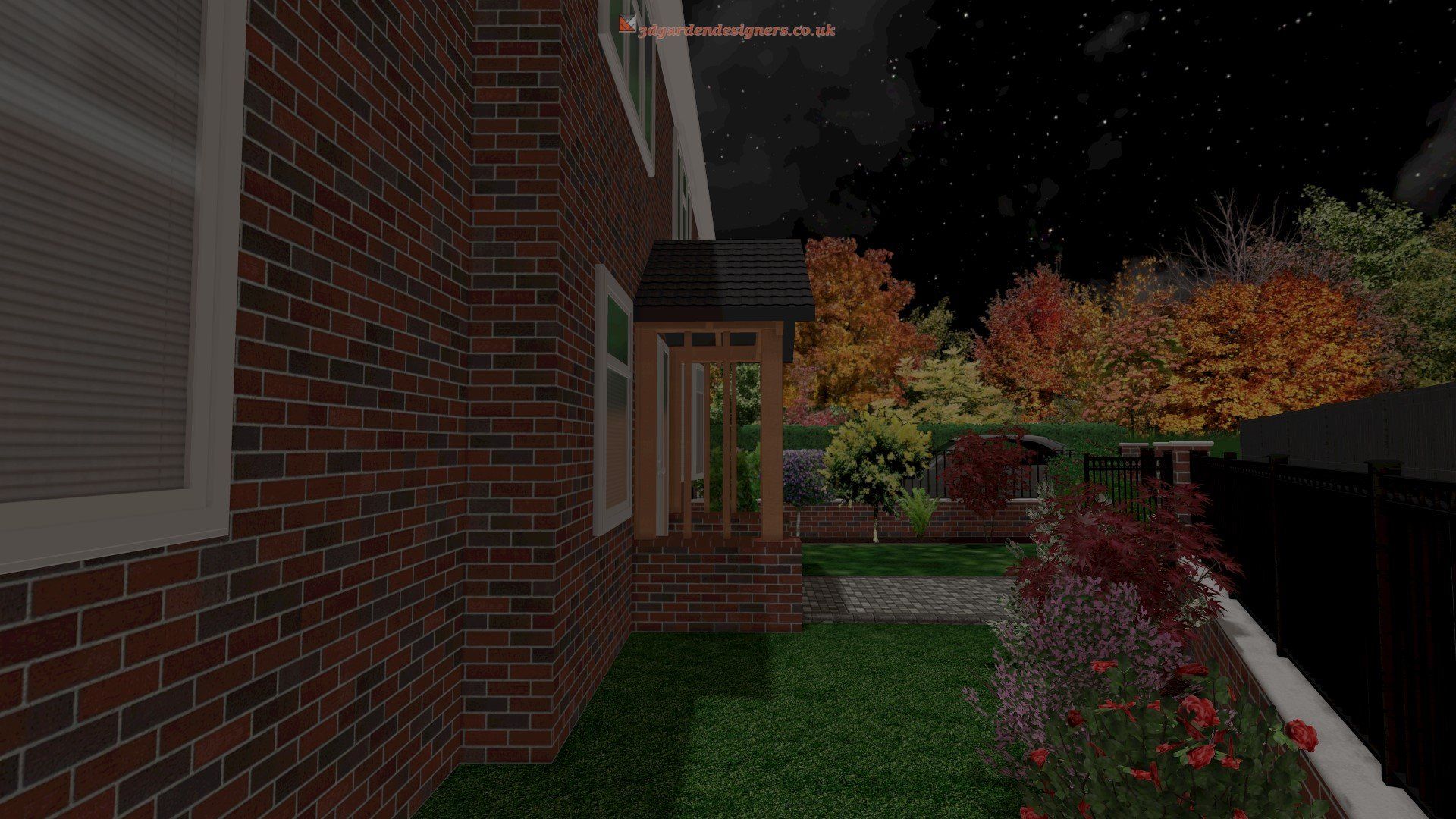 A brick house with a porch and a lush green yard at night.