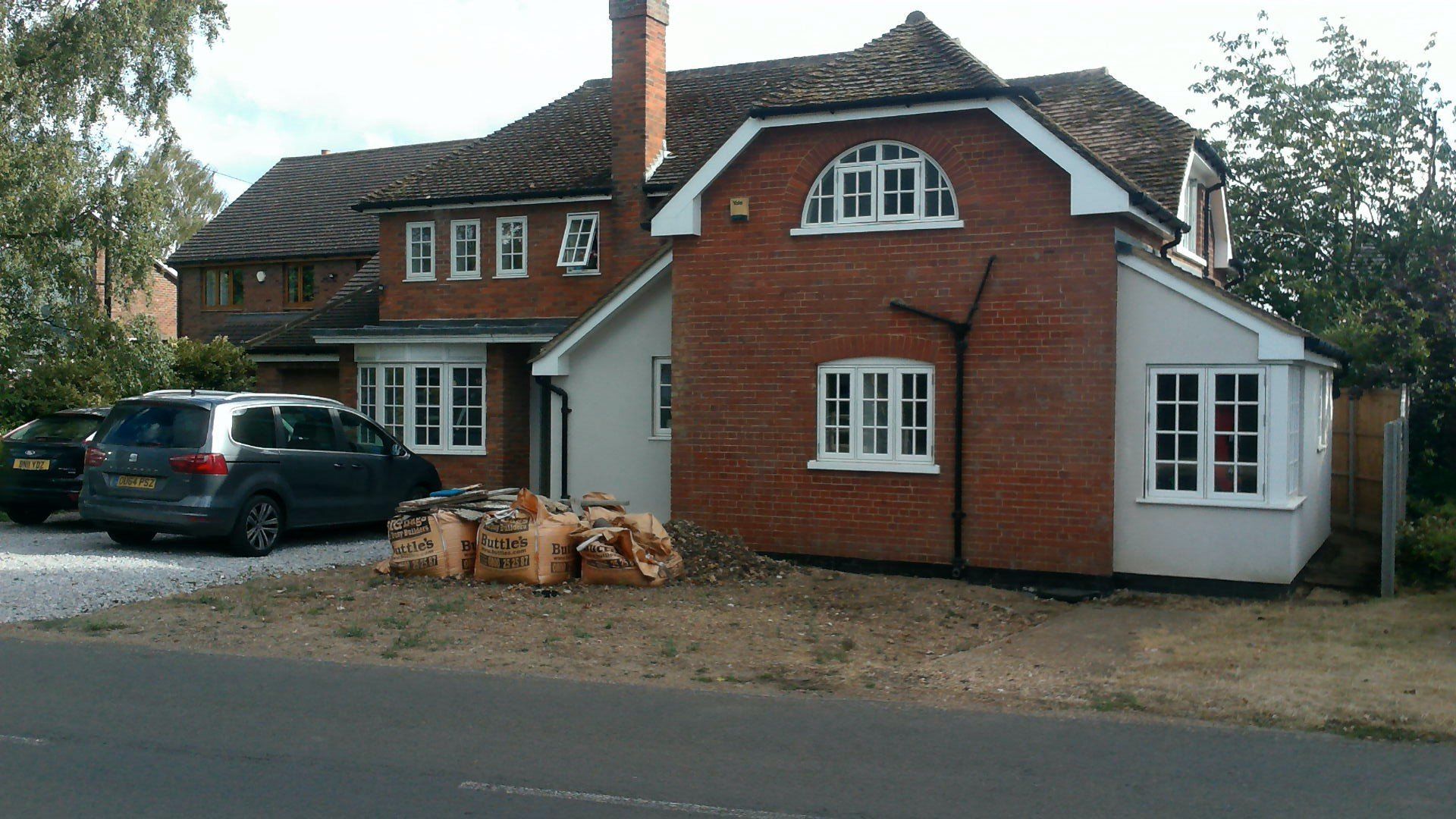 A brick house with a car parked in front of it