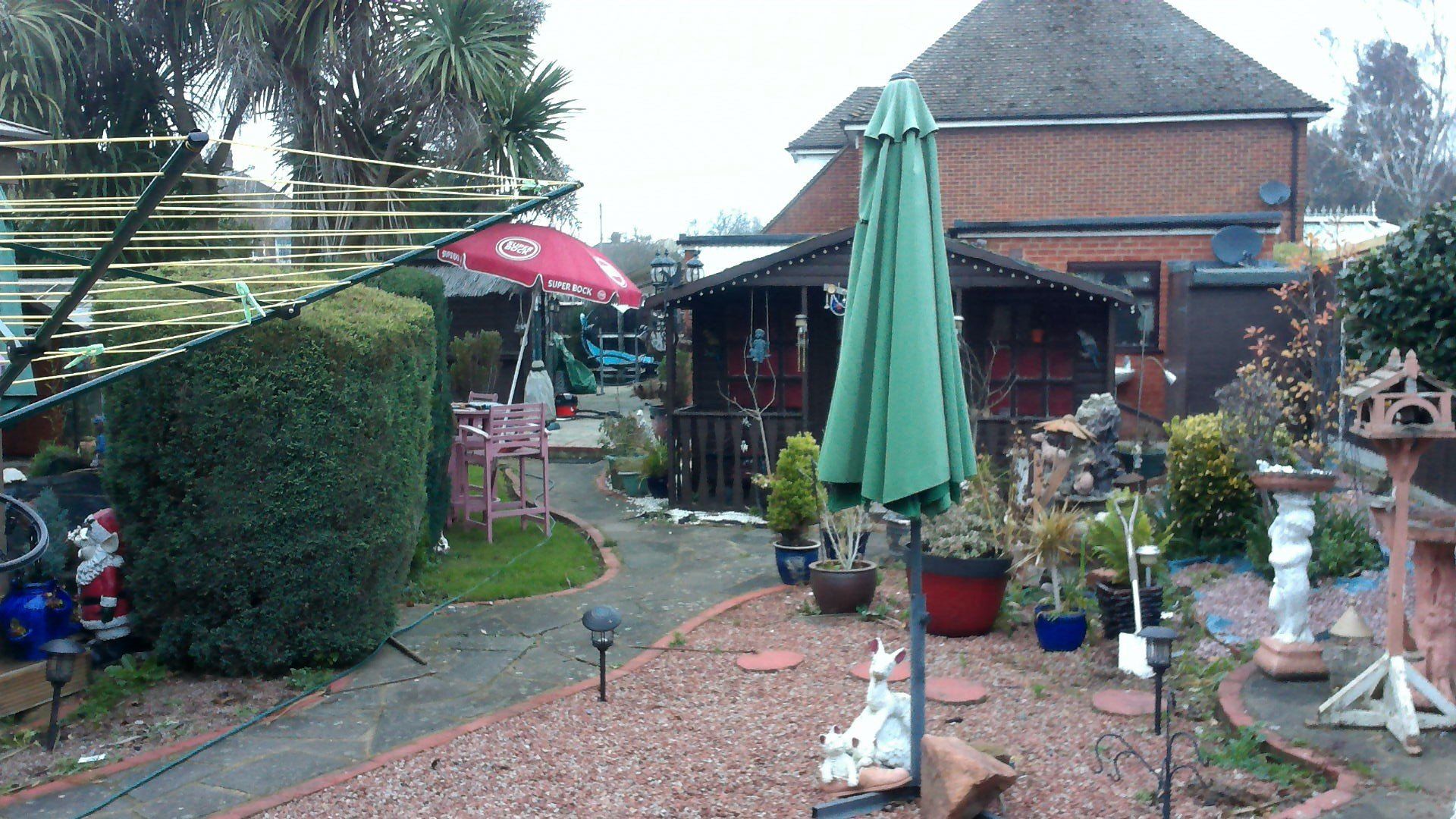 A house with a green umbrella in front of it