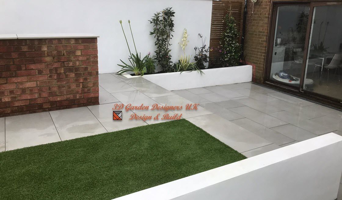 A patio with a brick wall and a sliding glass door.