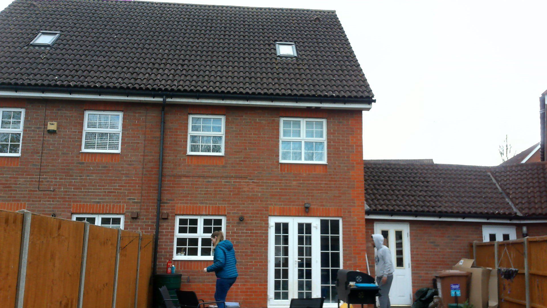 A brick house with a wooden fence in front of it