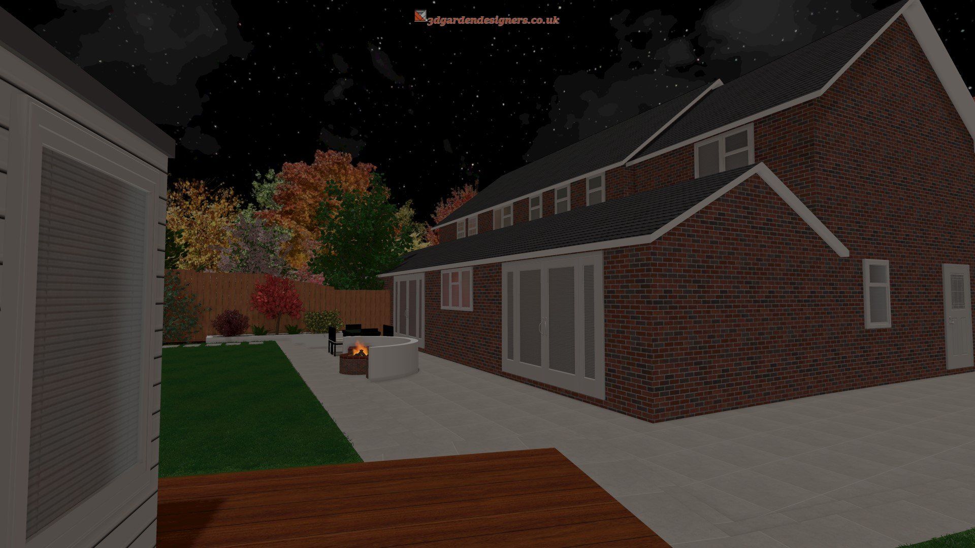 A brick house with a patio and a fire pit in the backyard at night.