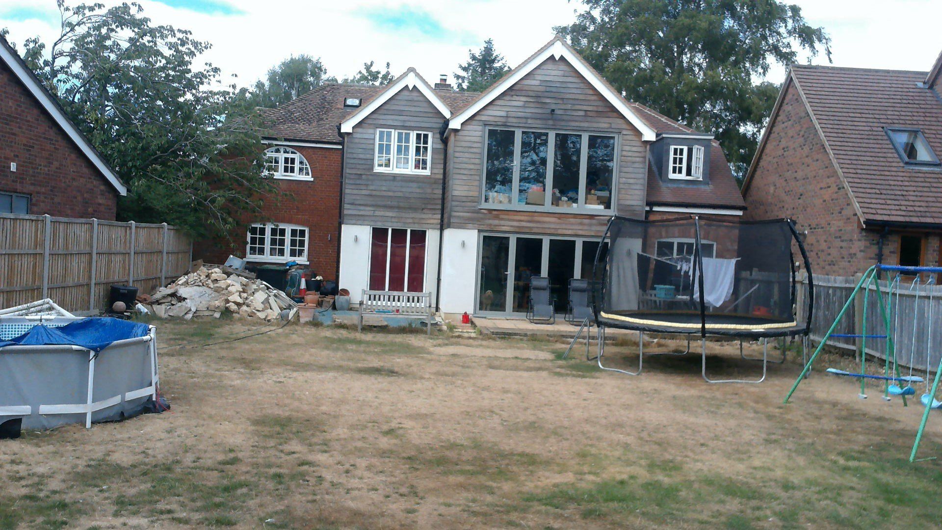 A large house with a trampoline in front of it