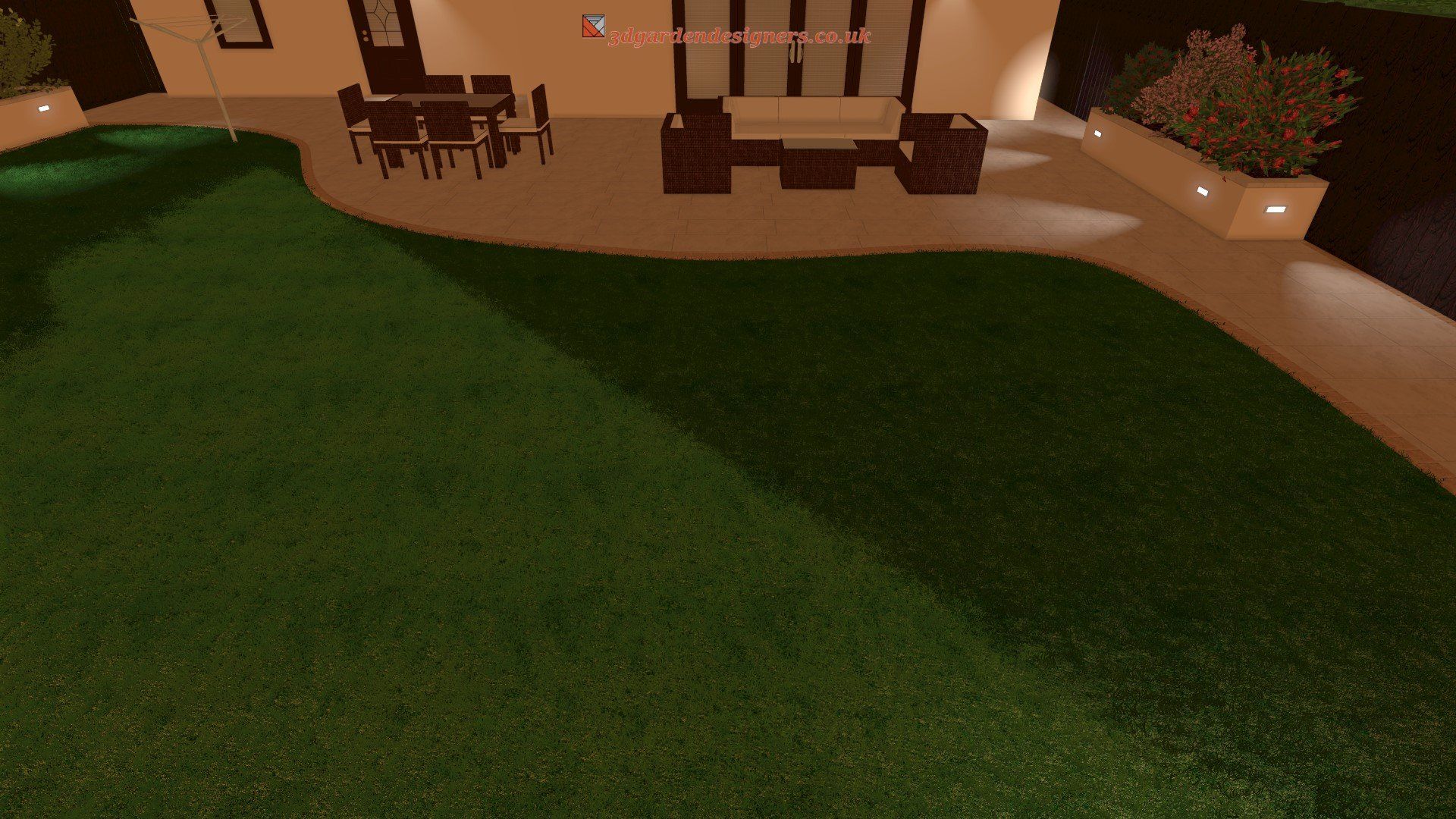 There is a large lawn in front of a house with a table and chairs.