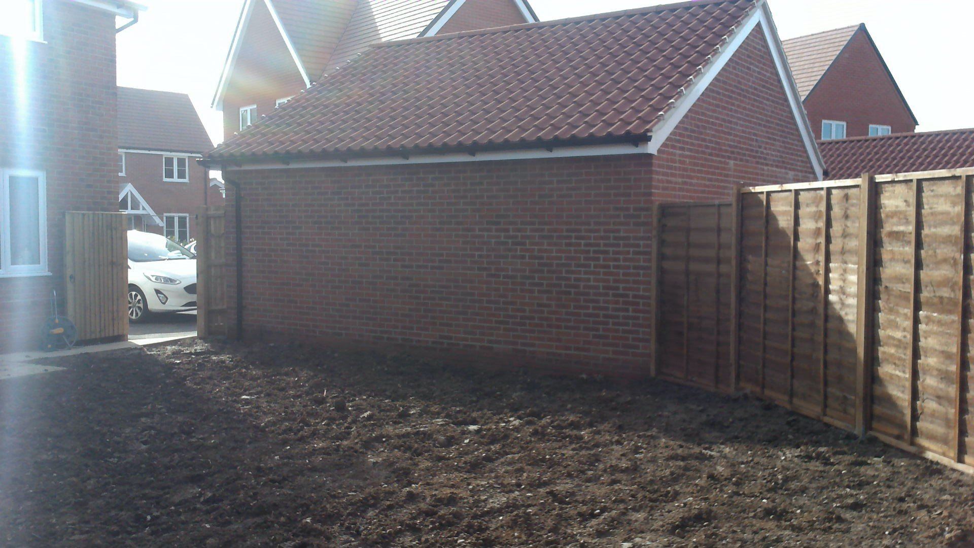 A brick building with a wooden fence in front of it