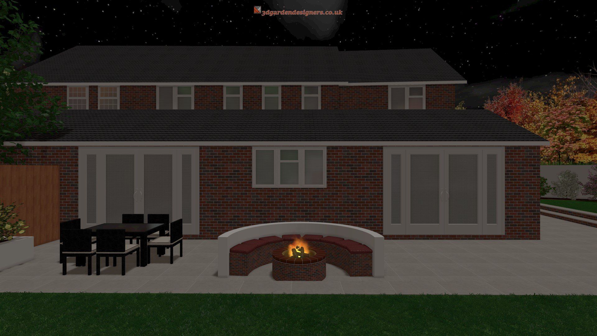 A brick house with a fire pit in the backyard at night.