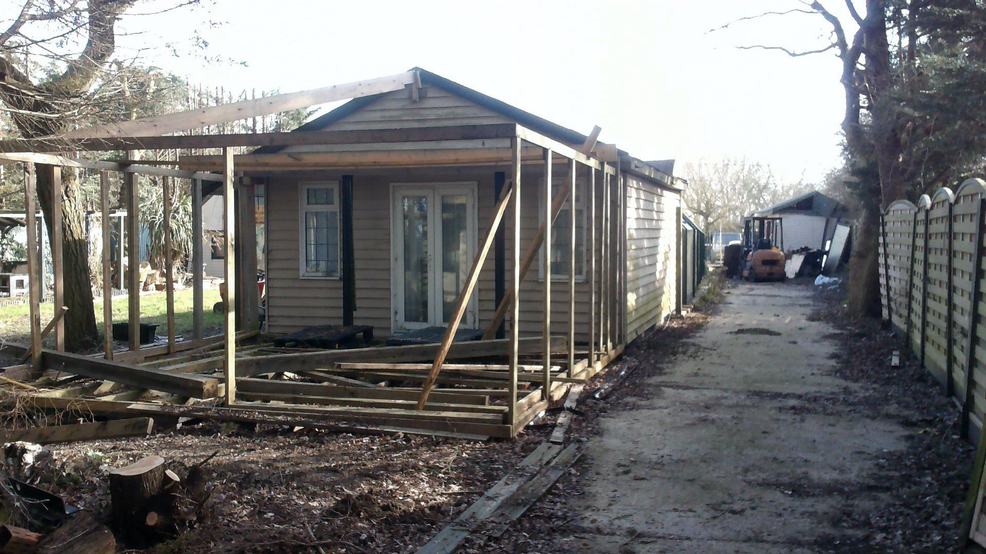 A house that is being built with a fence in the background