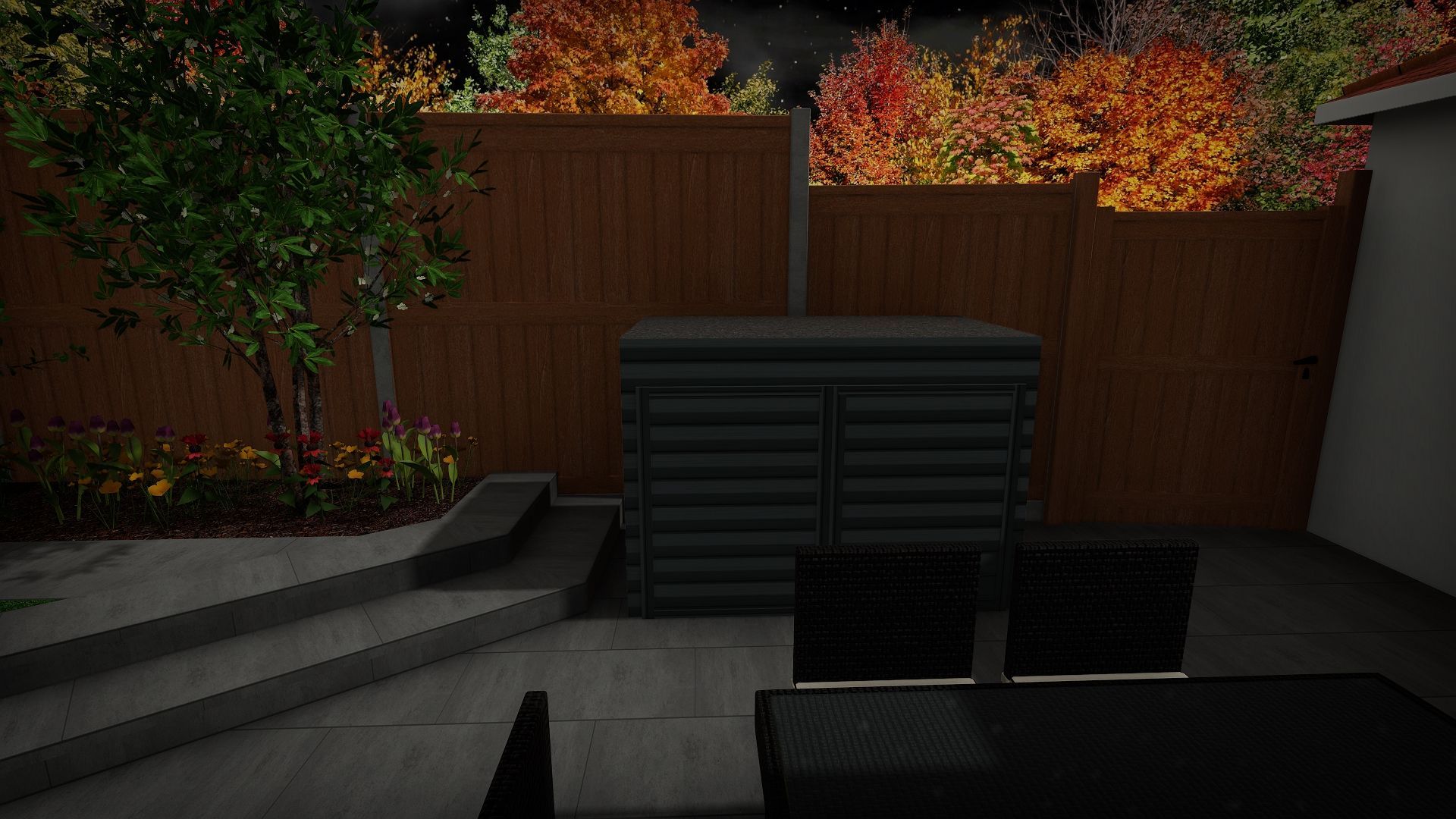 A patio with a table and chairs and a wooden fence at night.