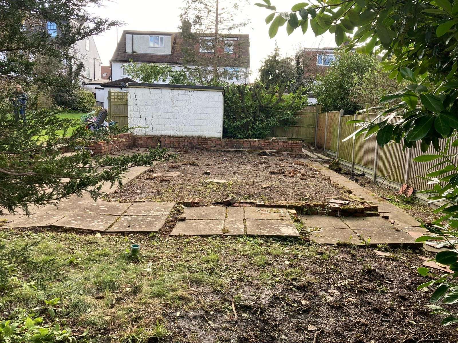 There is a lot of dirt in the backyard of a house.