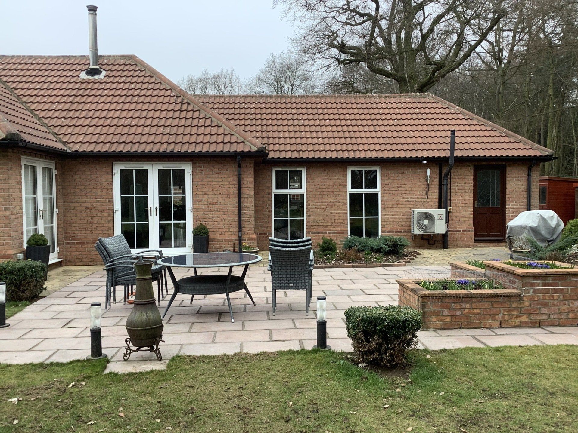 A brick house with a patio in front of it