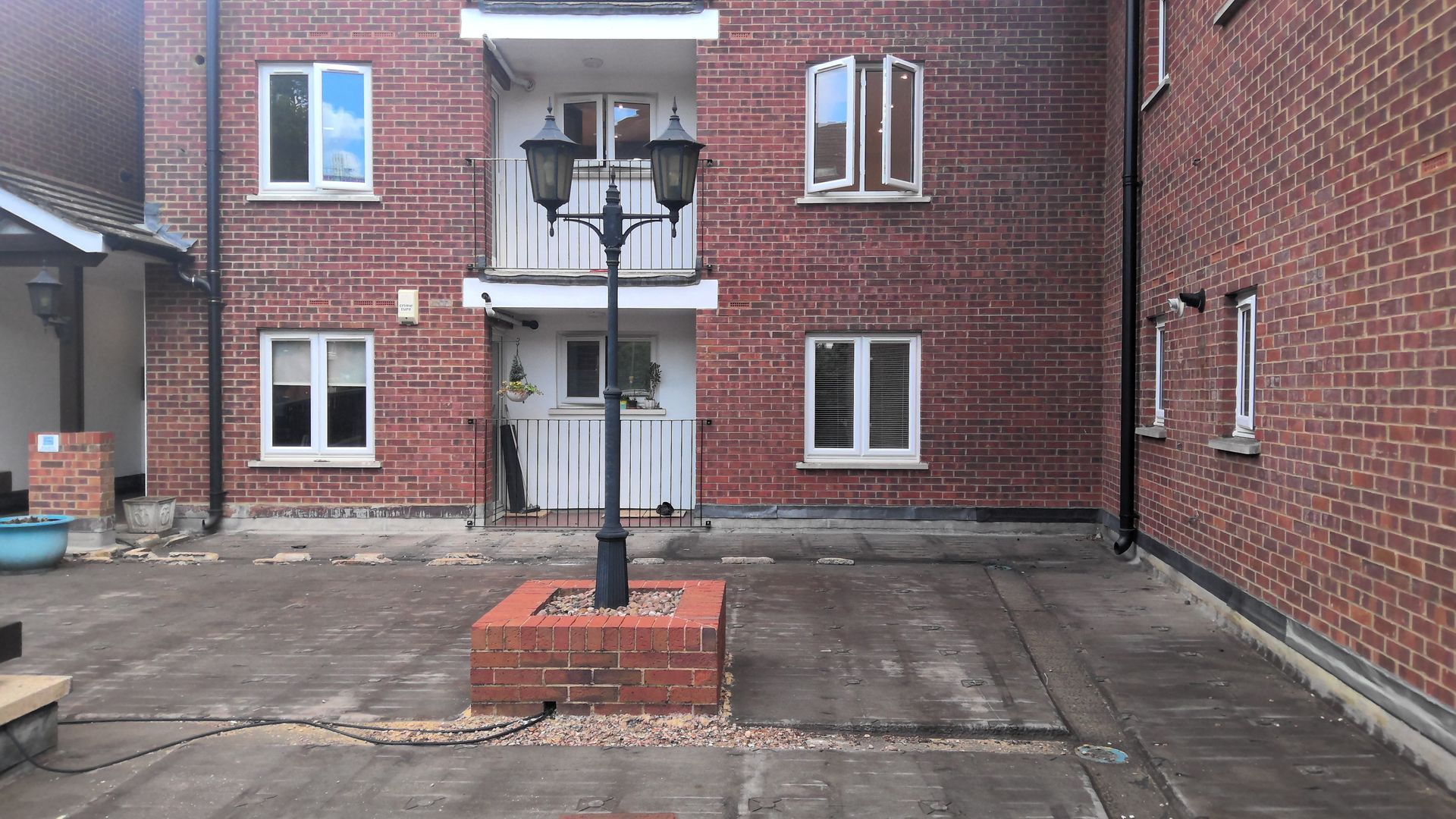 A brick building with a lamp post in front of it.