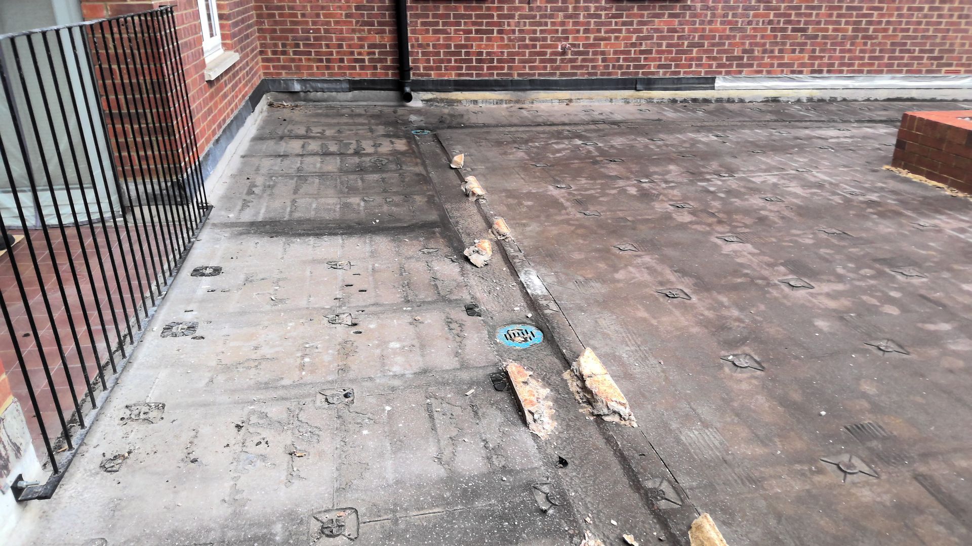 A brick building with a concrete patio in front of it.