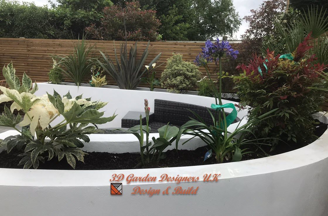 A white planter filled with lots of plants and flowers