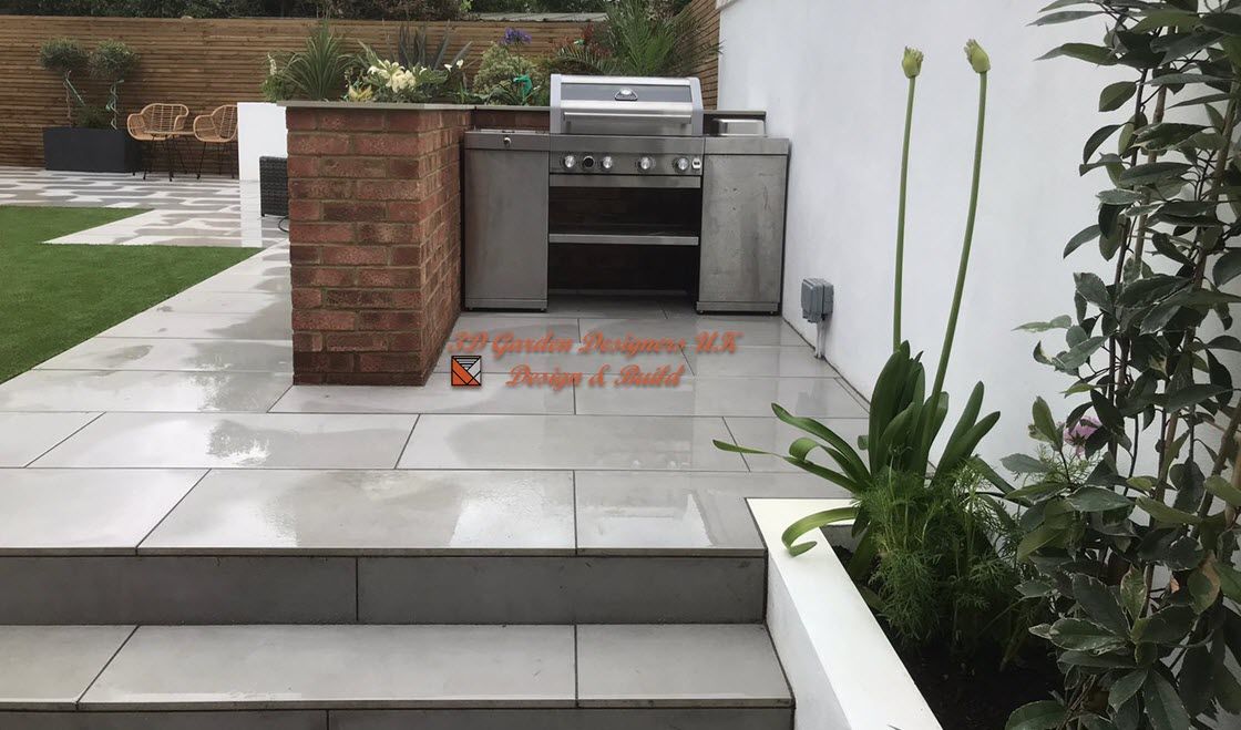 A patio with stairs leading up to a grill