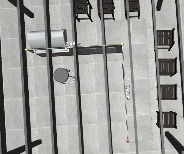 An aerial view of a balcony with chairs and a table