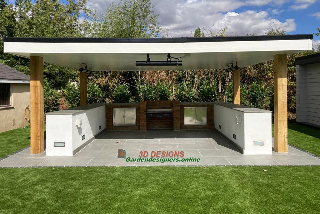 design and build A large outdoor kitchen is sitting on top of a lush green lawn.