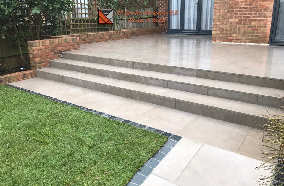 A set of stairs leading up to a patio in a backyard.