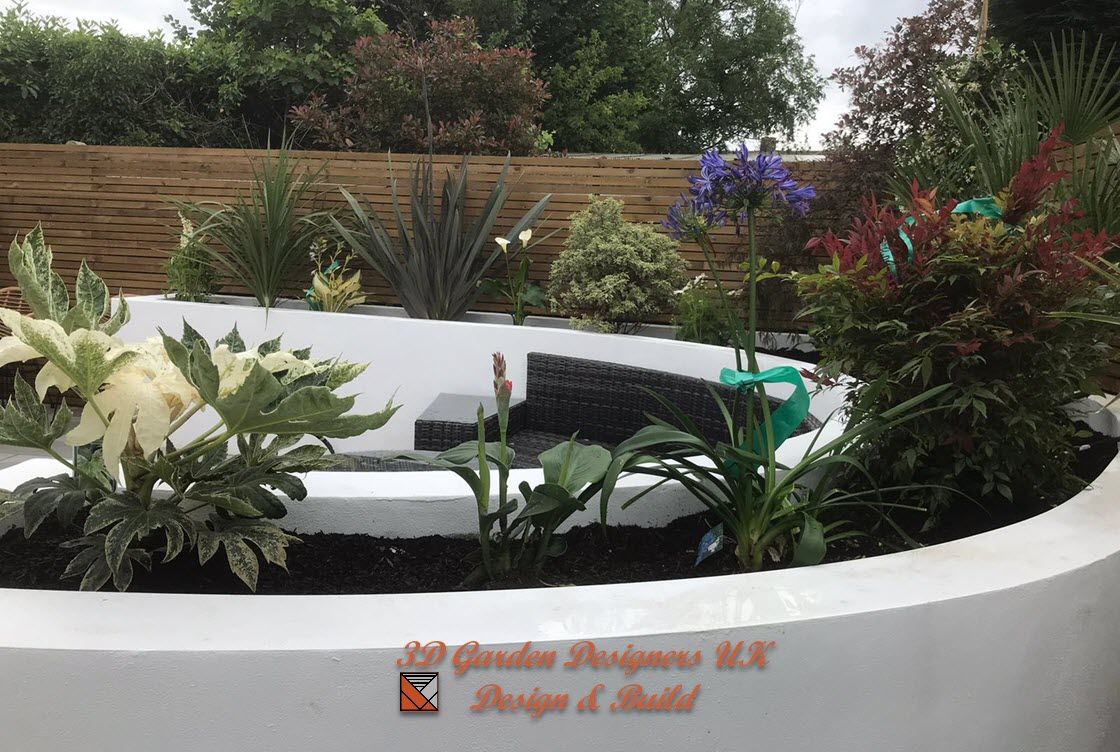 A white planter filled with lots of plants and flowers