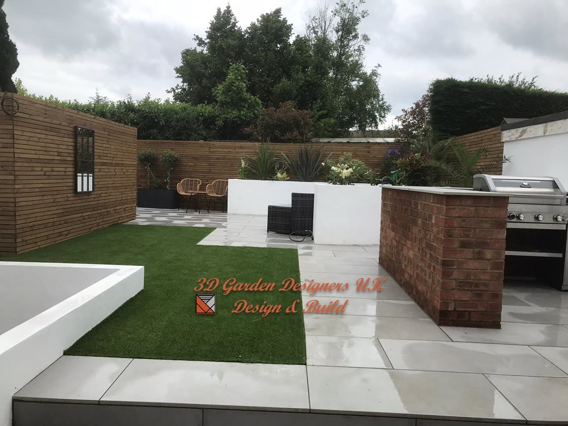 A garden with a grill and a brick wall