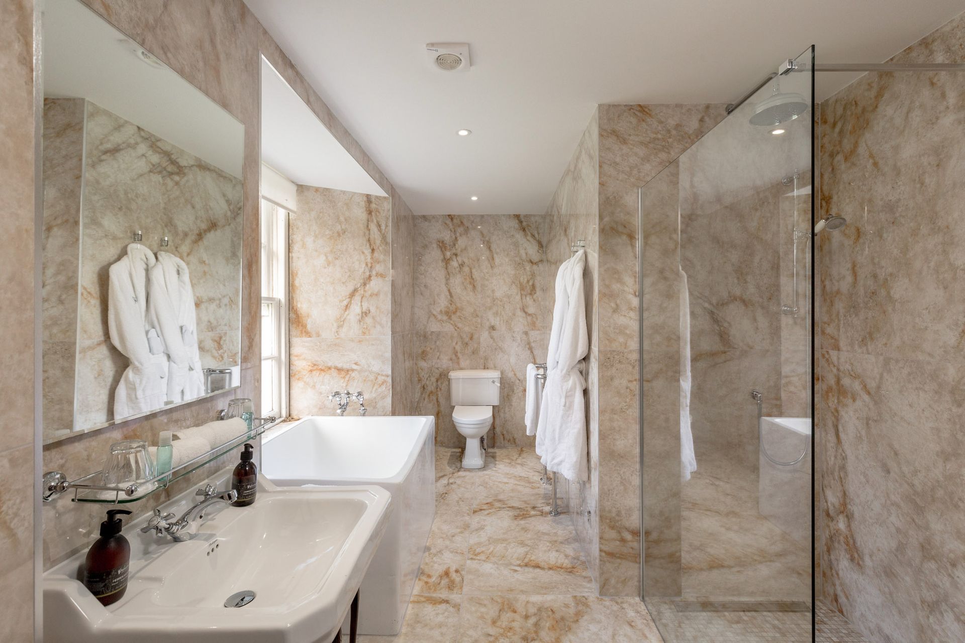 A bathroom with a sink, toilet, bathtub and walk in shower.