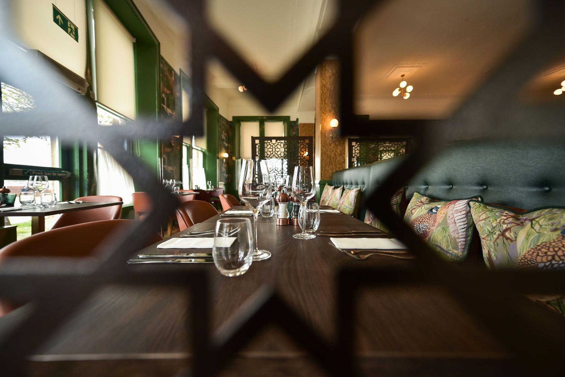 A restaurant with tables and chairs set up for a meal.