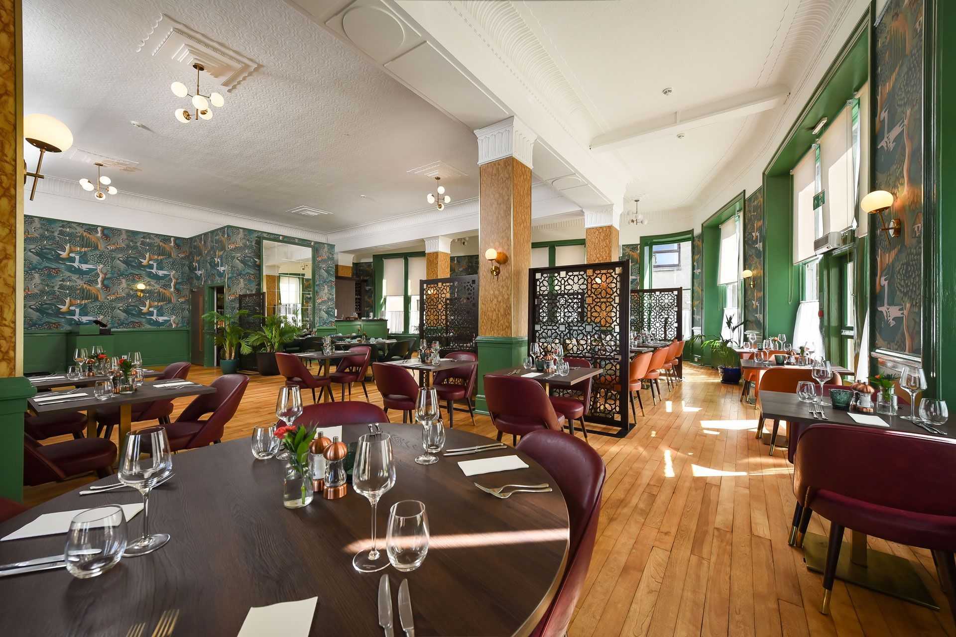A large dining room with tables and chairs set for a meal.