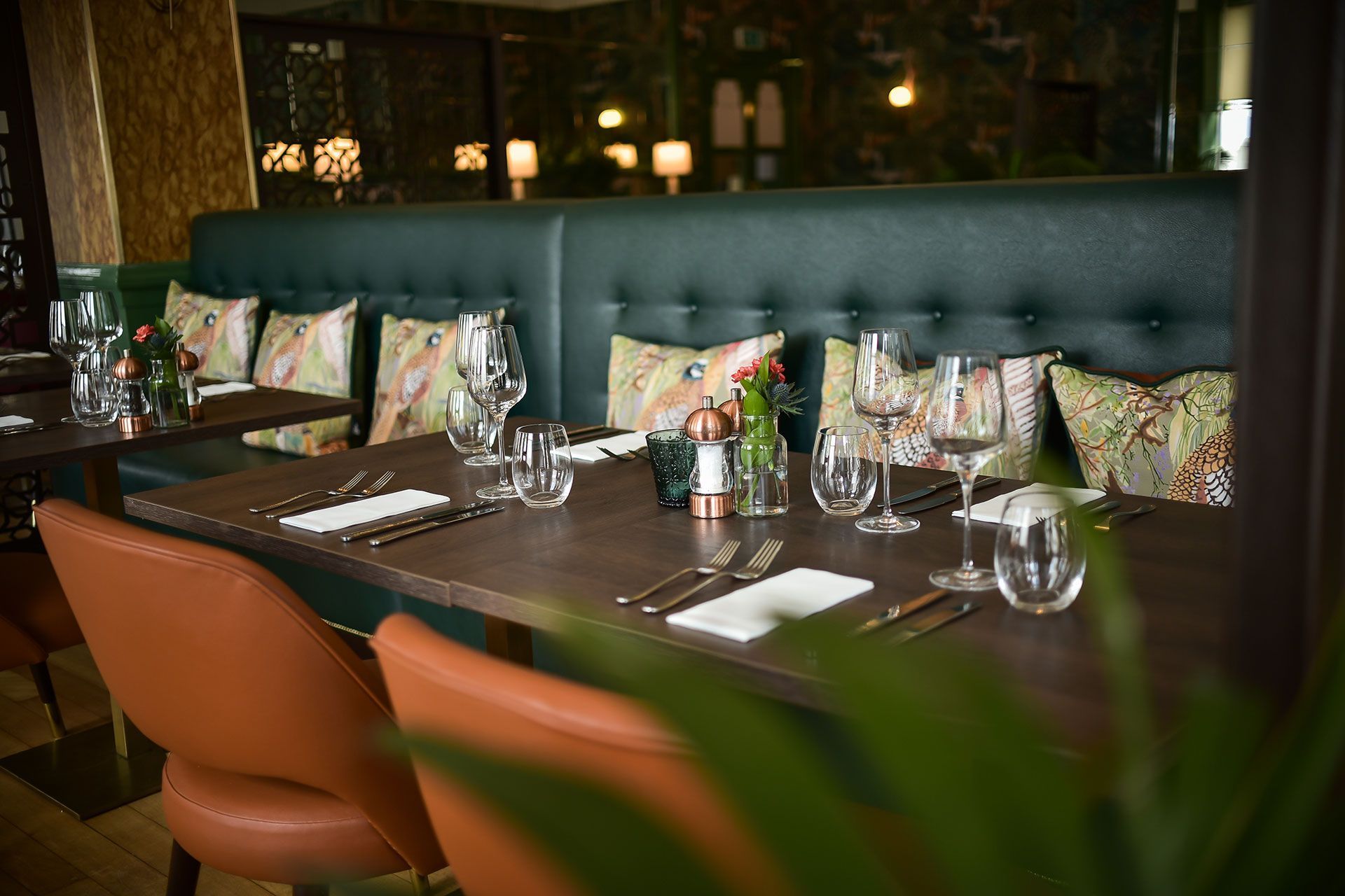 A restaurant dining room with tables and chairs set for a meal.