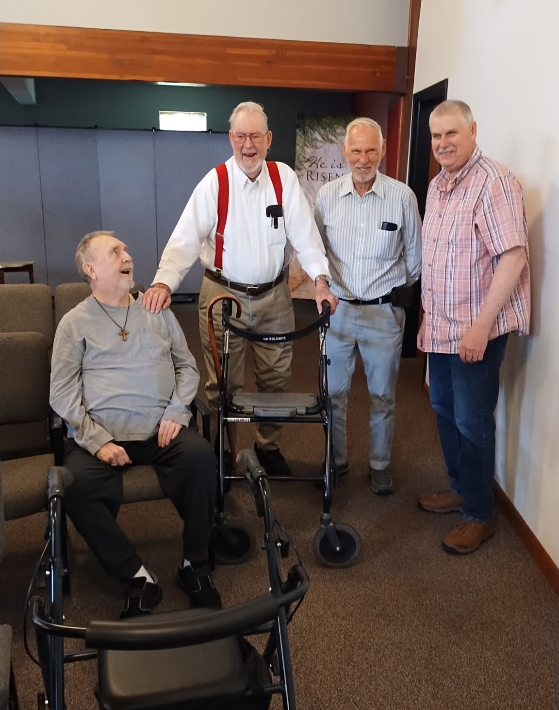 A group of men are standing next to each other in a room.