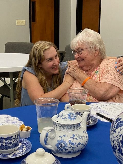 A group of women are posing for a picture at a table.