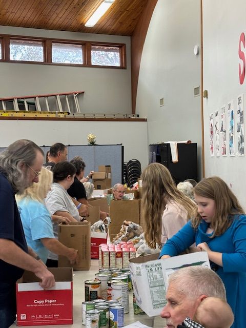 A group of women are posing for a picture in front of a van.