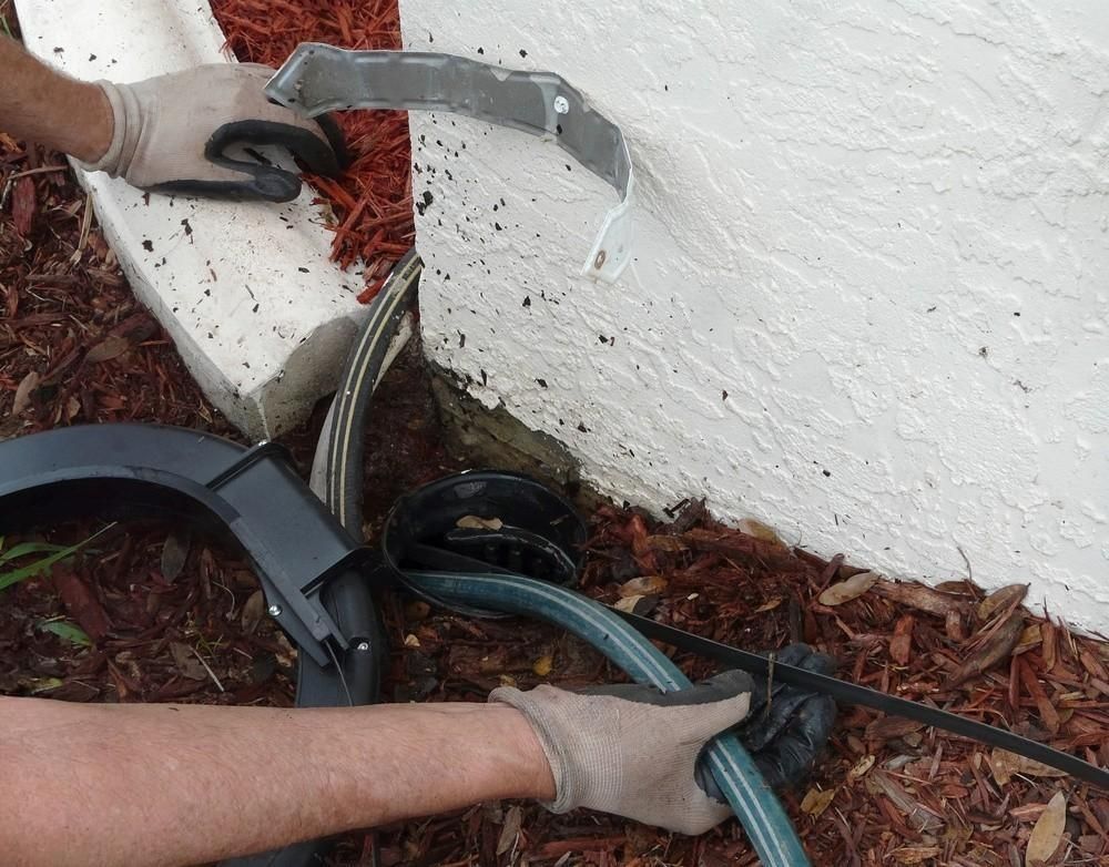 a person is using a vacuum hose to clean a drain