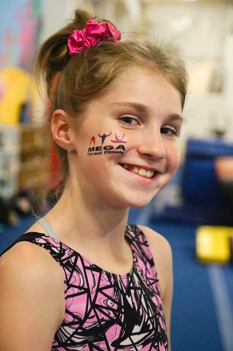 Gymnastics — Happy Teen With Sticker On Face in Novi, MI
